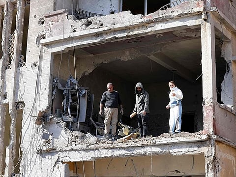 Residents check a flat heavily damaged by Israeli bombardment in the southern Lebanese city of Tyre on November 28, 2024, a day after a ceasefire between Israel and Hezbollah took hold.   