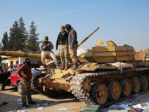 Militants seize a Syrian Army tank on the international M5 highway in the Zarbah area which was taken over by anti-government factions on November 29, 2024. 