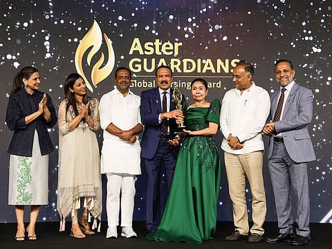 Nurse Maria Victoria Juan from Philippines – receives the Aster Guardians Global Nursing Award 2024 from Dr Azad Moopen in Bengaluru, India, on Thursday night. 