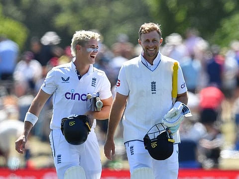 England's Jacob Bethell (left) and Joe Root leave the ground after the win during the fourth day of the first Test cricket match against New Zealand at Hagley Oval in Christchurch on Sunday.
