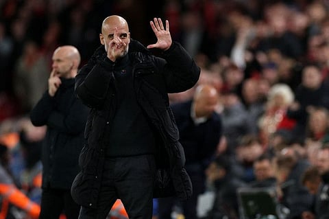 Manchester City's Spanish manager Pep Guardiola reacts to Liverpool fans chanting jeers during the English Premier League football match against Liverpool.
