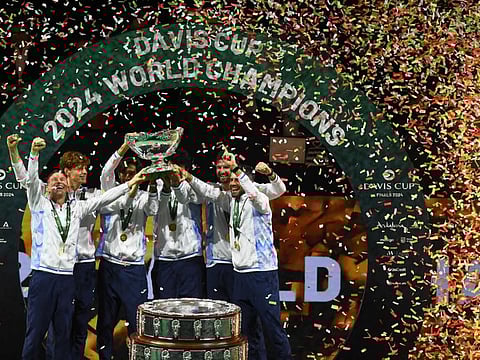 Team Italy celebrate with their trophy after winning the Davis Cup Finals at the Palacio de Deportes Jose Maria Martin Carpena arena in Malaga, southern Spain, on November 24.