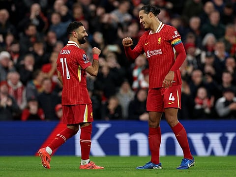 Liverpool's Egyptian striker Mohamed Salah (left) celebrates with Dutch defender Virgil van Dijk after scoring the team's second goal during the English Premier League football match against Manchester City at Anfield on Sunday.