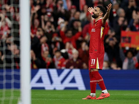 Liverpool's Egyptian striker Mohamed Salah celebrates scoring the team's second goal during the English Premier League football match against Manchester City at Anfield in Liverpool, north west England on Sunday.