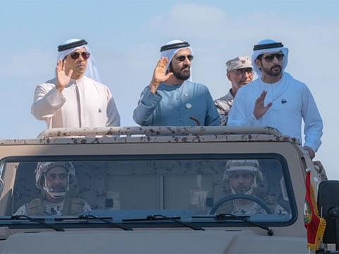 Sheikh Mohammed bin Rashid Al Maktoum (centre), Sheikh Mansour bin Zayed Al Nahyan (left) and Sheikh Hamdan bin Mohammed bin Rashid Al Maktoum during the 'Stand of Loyalty Parade' held to mark the 53rd Eid Al Etihad of UAE.