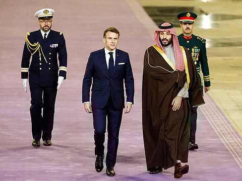 French President Emmanuel Macron (C) walks next to Saudi's Crown Prince Mohammed Bin Salman (2nd-R) ahead of their meeting in Riyadh on December 2, 2024. 