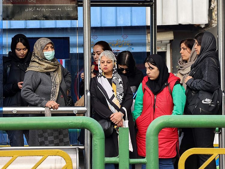 People wait for the bus in Tehran