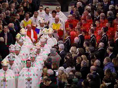 Guests stand as Clergy walk down the central isle of Notre-Dame Cathedral during a ceremony to mark the re-opening of the landmark cathedral, in central Paris, on December 7, 2024. 