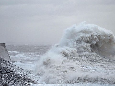 Waves crash against the sea wall and lighthouse at Porthcawl, south Wales, on December 7, 2024, as storm darragh brings winds of nearly 90 mph to the west of Wales and north-west England. 