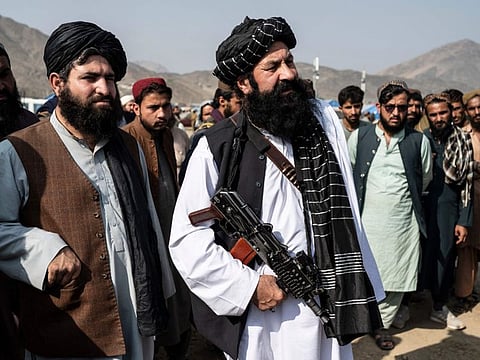 Afghanistan's minister for refugees Khalil Haqqani (centre) looks on as he arrives to inspect a refugee camp near the Afghanistan-Pakistan Torkham border in Nangarhar province on November 2, 2023.  