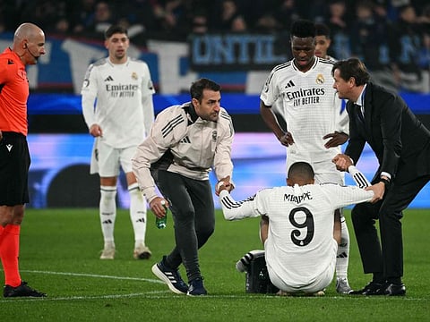 Real Madrid's French forward Kylian Mbappe leaves the pitch after an injury during the Uefa Champions League football match against Atalanta at the Gewiss Stadium in Bergamo, on December 10.
