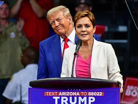 Republican US Senate candidate Kari Lake speaks alongside Trump during a campaign rally at Findlay Toyota Arena in Prescott Valley, Arizona, on October 13, 2024.  