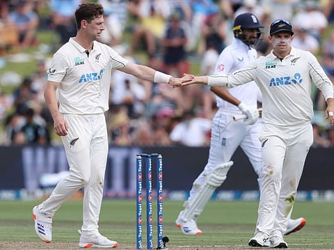New Zealands Matt Henry (left) and Tom Latham celebrate the fall of the last wicket of Englands Matthew Potts on day two of the third cricket Test match match at Seddon Park in Hamilton on Sunday.