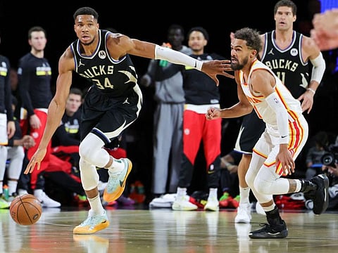 Giannis Antetokounmpo of the Milwaukee Bucks brings the ball up the court against Trae Young of the Atlanta Hawks in the first half of a semi-final game of the Emirates NBA Cup at T-Mobile Arena on Saturday.