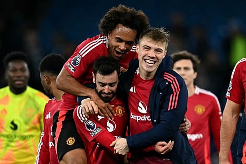 Manchester United's Dutch striker Joshua Zirkzee (left), Portuguese midfielder Bruno Fernandes (centre) and Danish striker Rasmus Hojlund celebrate following their win over Manchester City in the English Premier League football match at the Etihad Stadium in Manchester on Sunday.