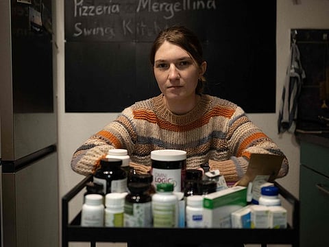 Andrea Vanek poses for a picture in her apartment in Vienna, Austria on November 22, 2024. Andrea Vanek was studying to be an arts and craft teacher, when spells of dizziness and heart palpitations suddenly started to make it impossible for her to even take short walks more than three years ago. 
