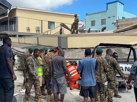 This screengrab taken from handout video footage posted on the Facebook account of Michael Thompson on December 17, 2024 shows security forces and rescuers inspecting a damaged car trapped underneath a collapsed building in Vanuatu's capital Port Vila after a powerful earthquake hit the Pacific island. 