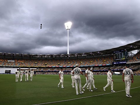 Australias captain Pat Cummins leads his team off the ground due to a rain delay on day five of the third cricket Test match agianst India at The Gabba in Brisbane on Wednesday.