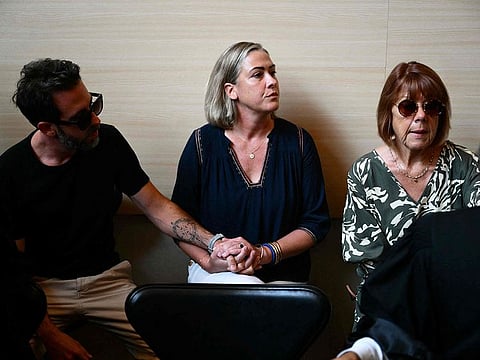 Gisele Pelicot (R) sits beside her daughter Caroline Darian (C) and her son (L) at the courthouse during the trial of her husband accused of drugging her for nearly ten years and inviting strangers to rape her at their home in Mazan, a small town in the south of France, in Avignon, on September 2, 2024.
