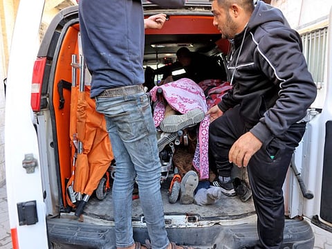 An ambulance carrying the bodies of people killed during an Israeli strike on Jabalia, in the northern Gaza Strip, arrives at Al Ahli Arab hospital, also known as the Baptist hospital, in Gaza City on December 19, 2024.  