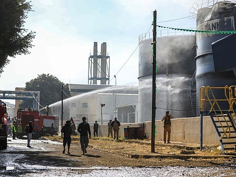 Yemeni firefighters douse oil tanks with water at a power station that was hit in an Israeli airstrike in the Houthi-run capital Sanaa on December 19, 2024.  