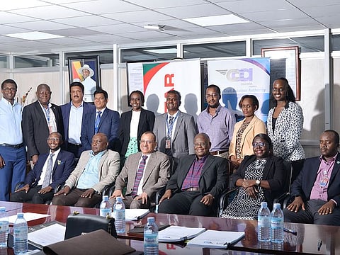 Group CEO of Tristar, Eugene Mayne (seated 3rd from left) and Director General of UCAA, Fred Bamwesigye (seated 3rd from right) with senior management staff and legal counsels from both sides