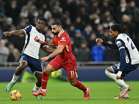 Liverpool's Egyptian striker Mohamed Salah vies with Tottenham Hotspur's Malian midfielder Yves Bissouma and English defender Djed Spence during the English Premier League football match at the Tottenham Hotspur Stadium in London on Sunday.