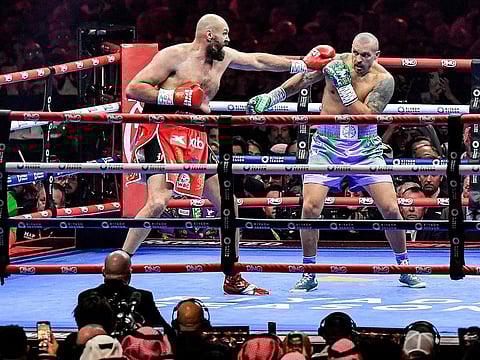Britain's Tyson Fury (red) and Ukraine's Oleksandr Usyk (blue) compete during their heavyweight world championship rematch at the Kingdom Arena in Riyadh on December 22, 2024. 