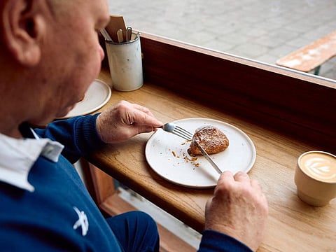A Briton is eating a croissant dough mince pie at Pophams bakery in London on December 20, 2024.  