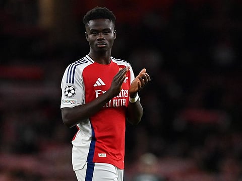 Arsenal's English midfielder Bukayo Saka applauds the fans following the Uefa Champions League football match against Monaco at the Emirates Stadium in north London, on December 11.