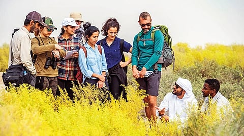 Salem Al Menhali and Mustafa Hamid Eltoum from the EAD-Al Wathba explain the biodiversity of the place to visitors 