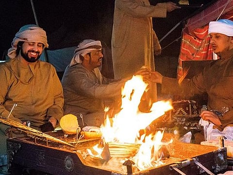 Nayef Al Mesaabi, right, takes over entertaining friends and family while his brother Ahmad does his military service 