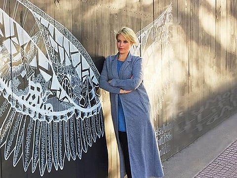 Kelsey Montague with her work in Buenos Aires. The artist has created over 125 murals all over the world 