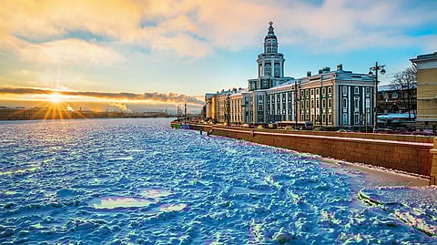 The Winter Palace dominates a frozen Neva river. 