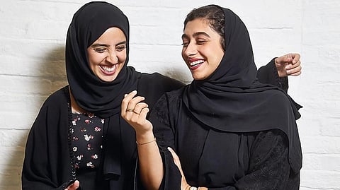 Nour Al Harmoodi and Soukaina Ben Bihi, youth activators, share a light moment at the Hub X 