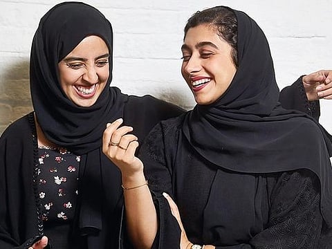 Nour Al Harmoodi and Soukaina Ben Bihi, youth activators, share a light moment at the Hub X 