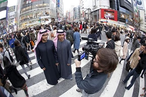 In Japan: Mohamed, left, and brother Payman filming Planet Peeta. 