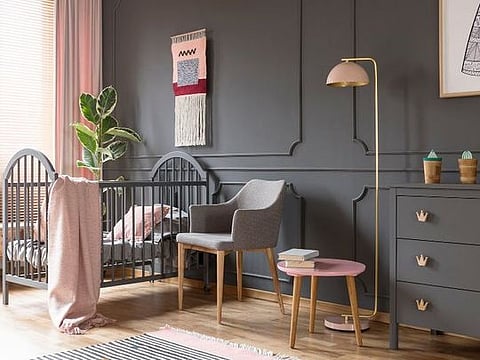 En vogue dark wall colours can work beautifully in a child's room paired with some pastels and light wood furnishings