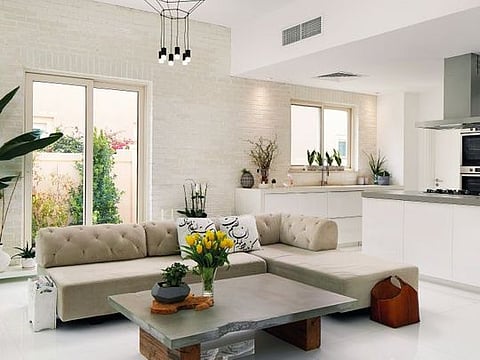 Open Plan: Kitchen from IKEA, the quartz counter from Al Mezoon Marble and the bar stools are Kartell. In the living room, the sofa is from West Elm &amp; coffee table is a custom design