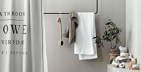 Bathroom accessories all from H&amp;M Home; wooden tray, Dh29; towels from Dh29.