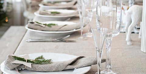 Good-quality plain linen is a worthwhile investment, acting as a backdrop to all kinds of party themes, be it undeniably rustic, bright and festive, or more formal. Here it successfully unites sparkling glass and an ornate candelabra, with sprigs of fresh herbs and greenery. Source: Living4Media