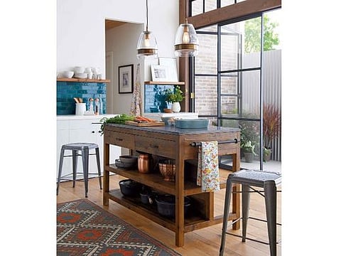 This enviable kitchen space by Crate &amp; Barrel is dominated by its characterful butcher’s block that incorporates useful drawers and shelving.