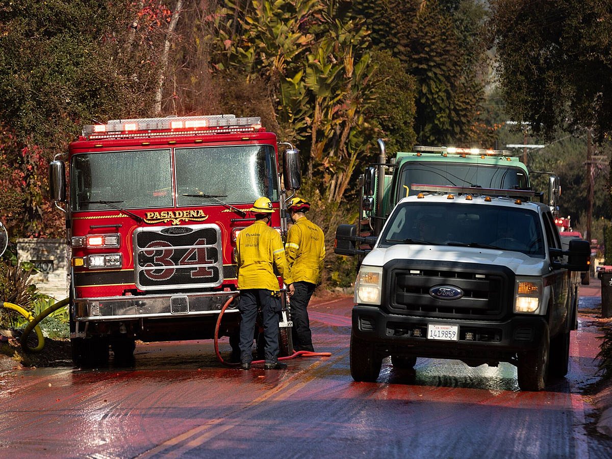 Firefighters race to beat Los Angeles fires as winds grow and death ...