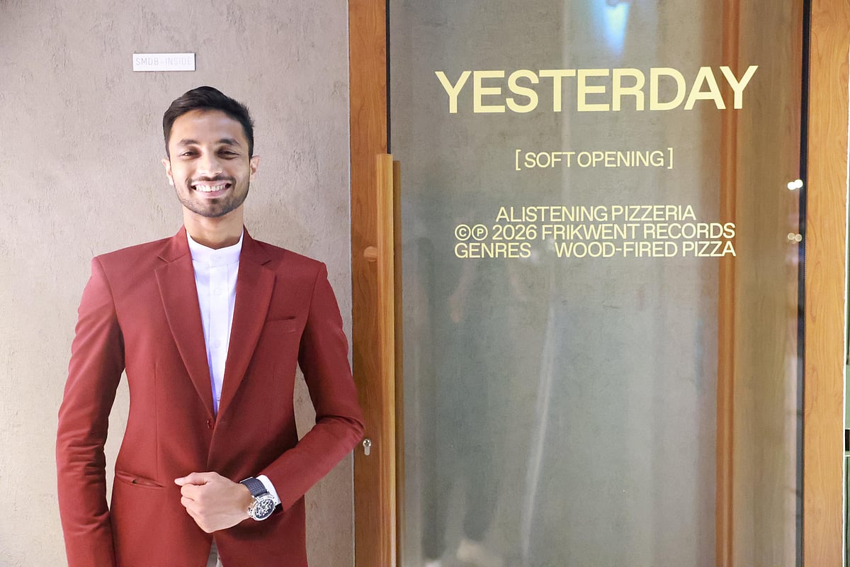Restaurant manager smiling in front of door