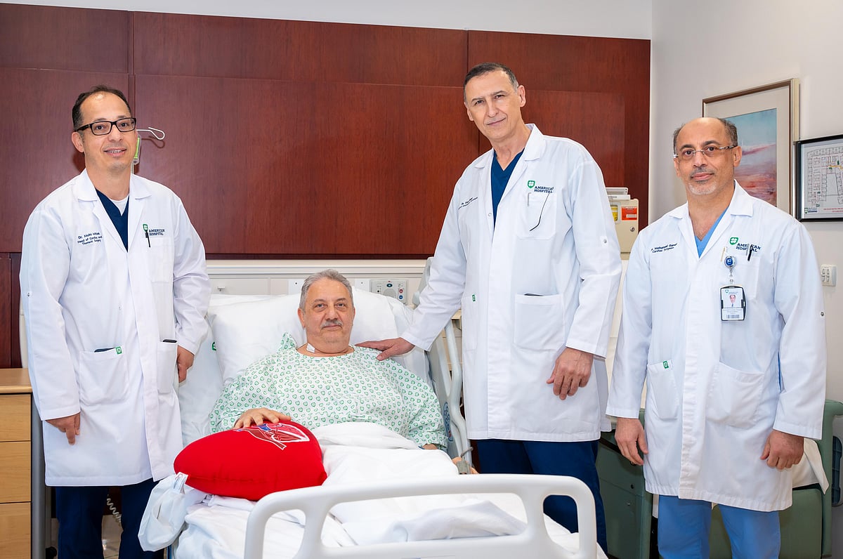 Surgeons operate the Da Vinci Xi robotic system to perform a precise heart valve repair in a sterile theater.