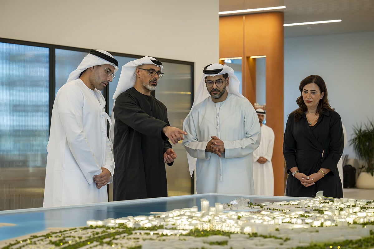 A modern waterfront city development on Saadiyat Island with luxury high-rise buildings and docked yachts.
