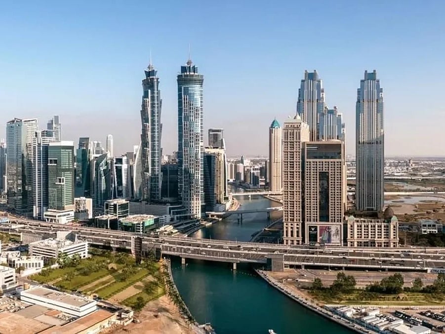 A digital rendering of luxury Dubai skyscrapers reflecting on a glass surface with integrated blockchain data overlays.
