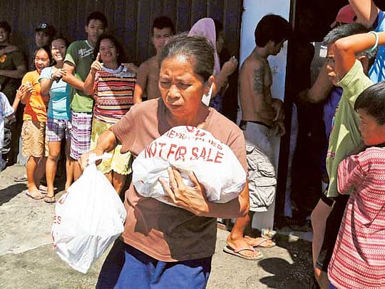 Eight Filipinos die in stampede at rice warehouse