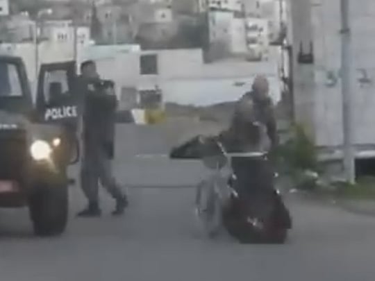 Israeli soldier pushes disabled man out of wheelchair