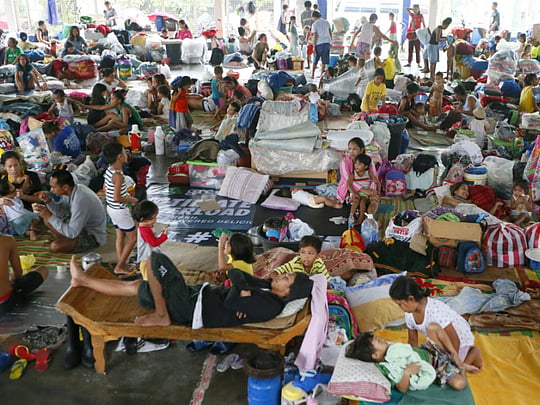Five dead, tens of thousands flee Philippine floods
